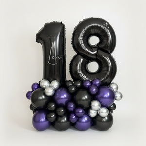 Black, purple, and silver balloon arrangement with 'Levi' on a white background